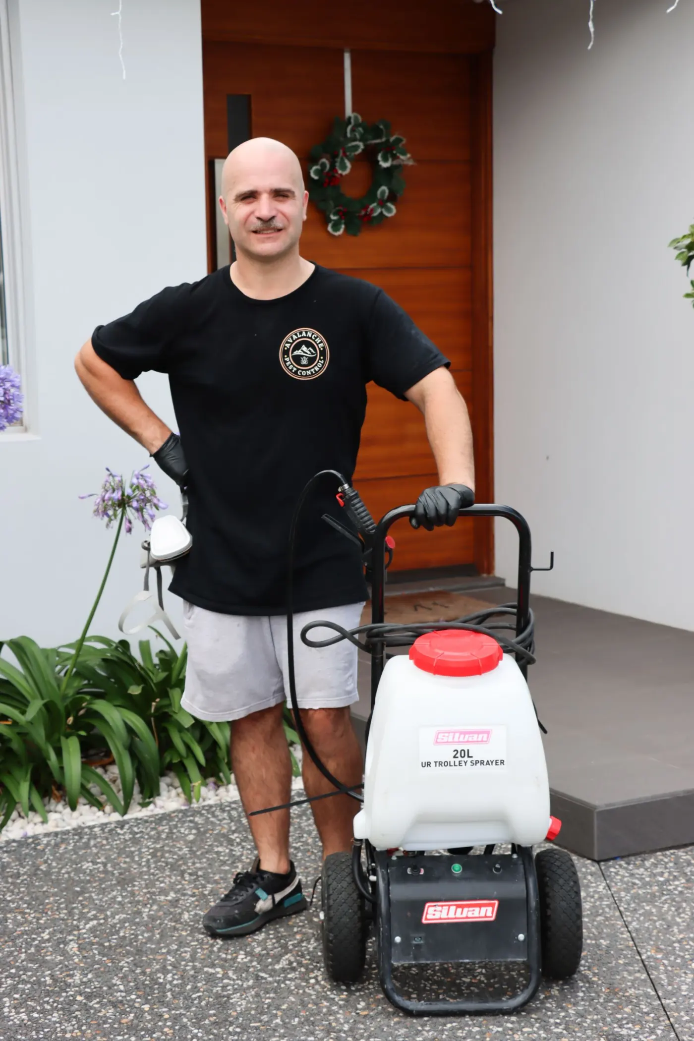 Avalanche Pest Control's Simon with his sprayer at an Illawarra home